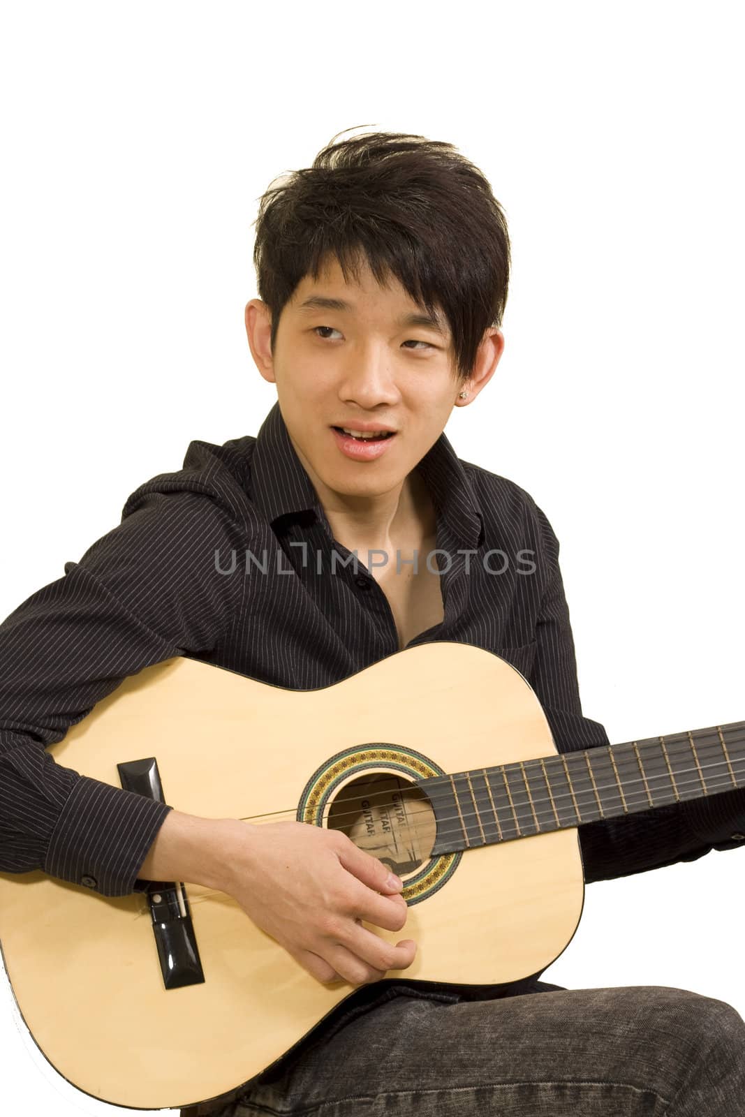 asia boy plays his guitar 