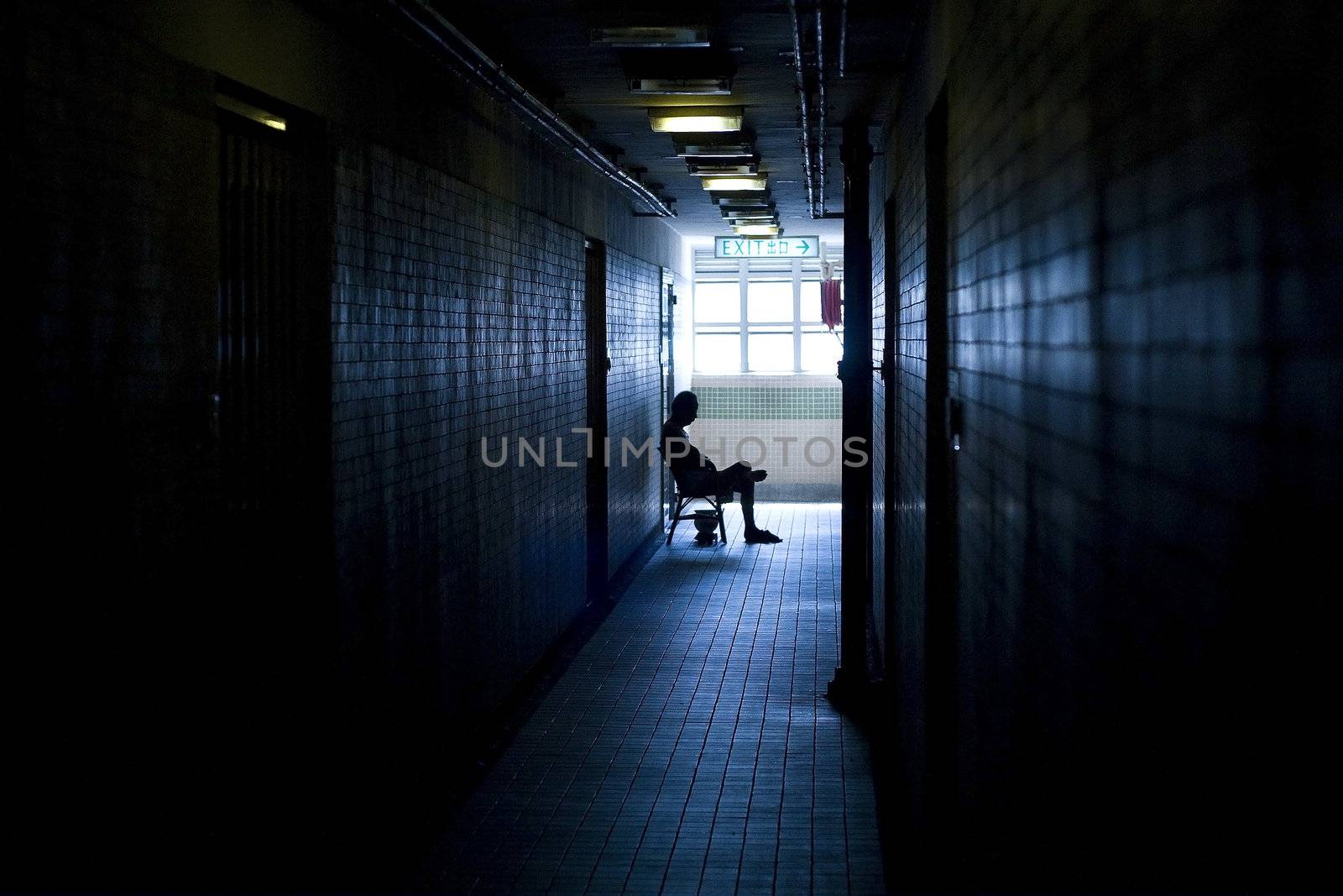 man sitting in the corridor in a building