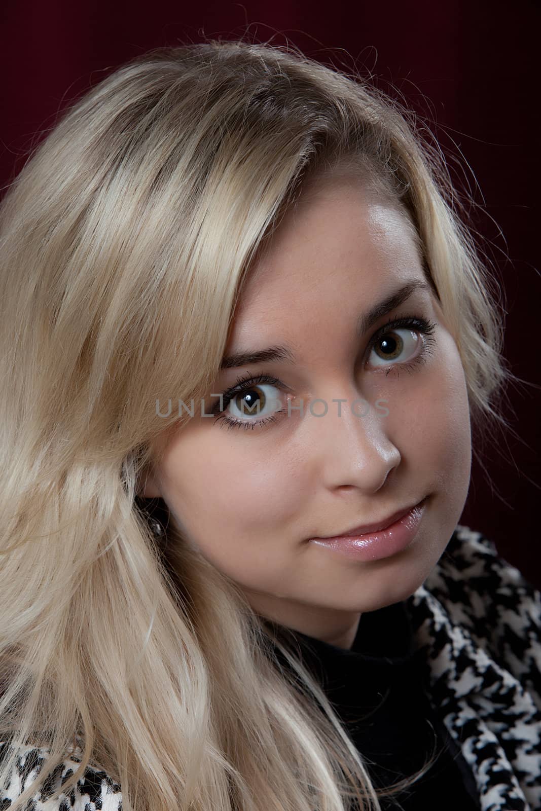 Portrait of the young beautiful girl on a dark background