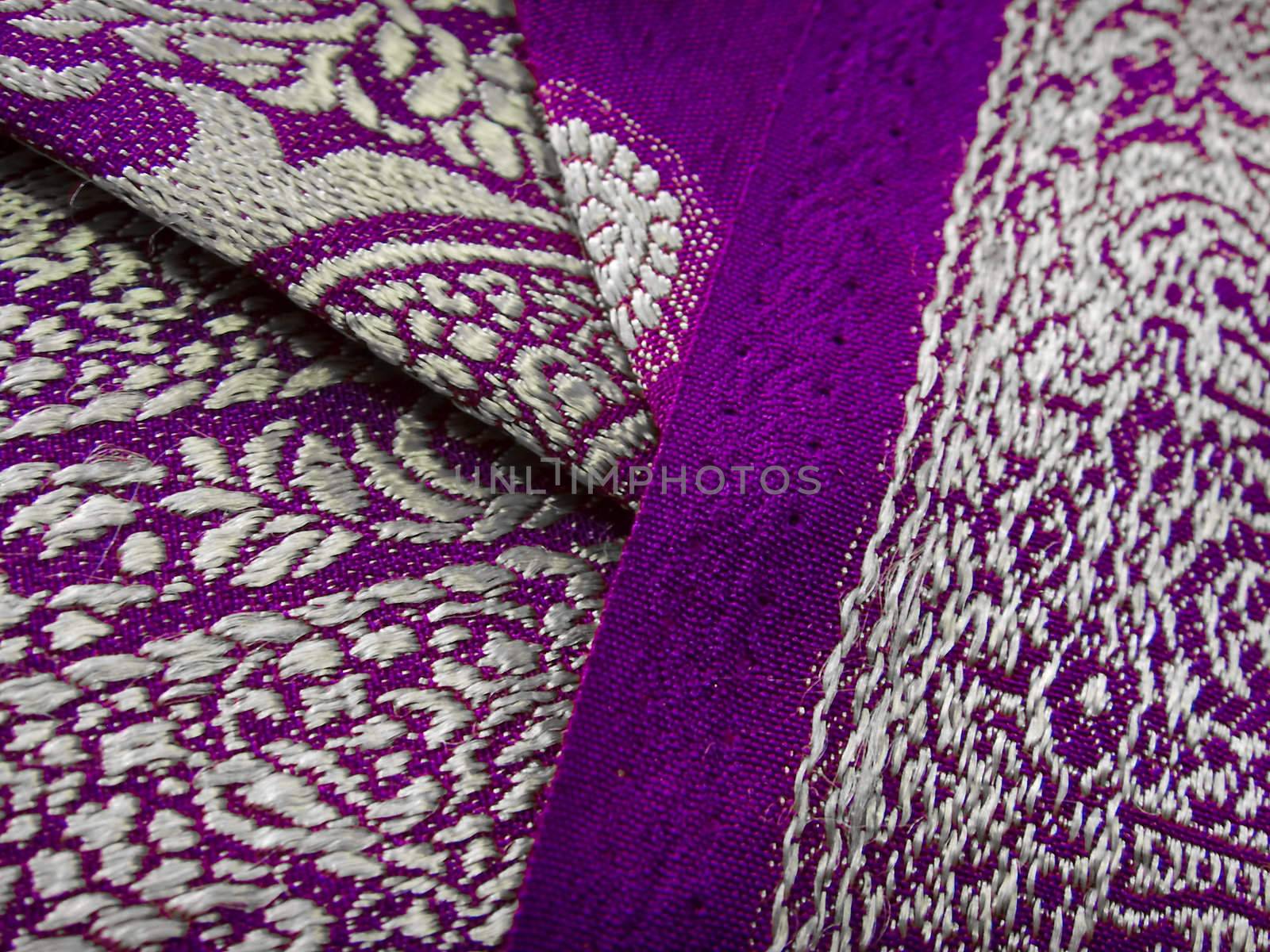 Closeup of a purple and grey saree with floral designs