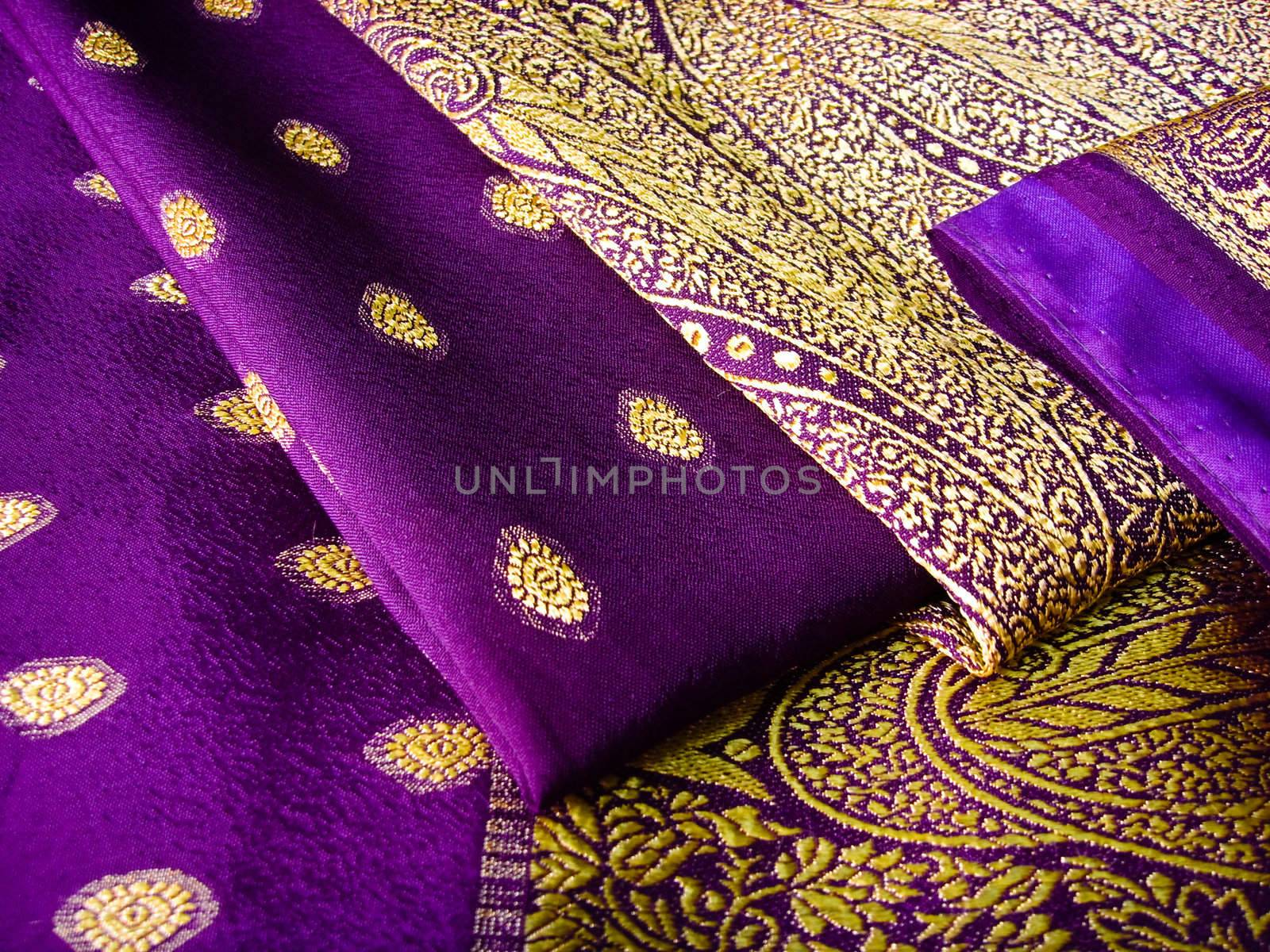 A purple saree folded in three with beautiful embroidery