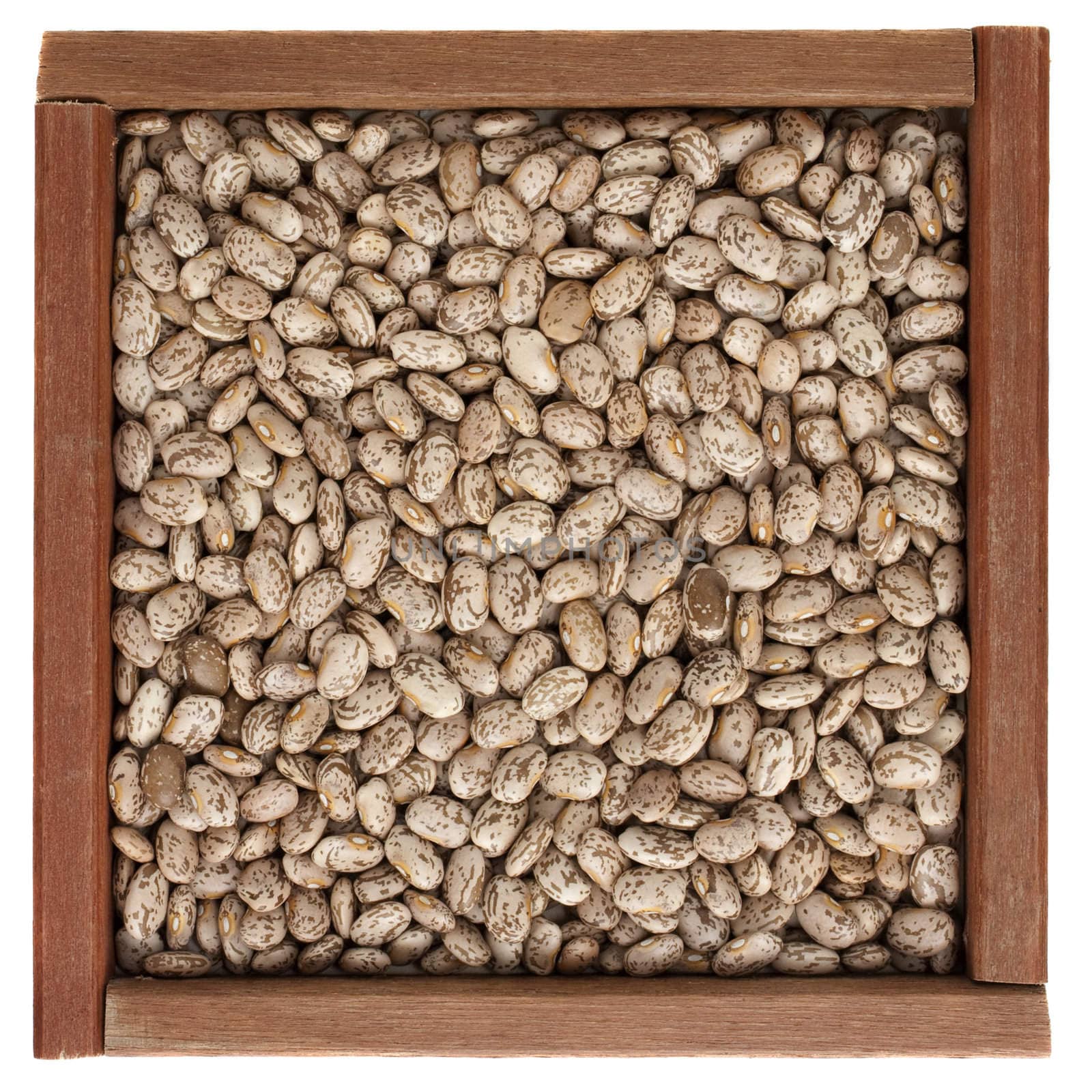 pinto beans in a square, rustic, wooden box isolated on white