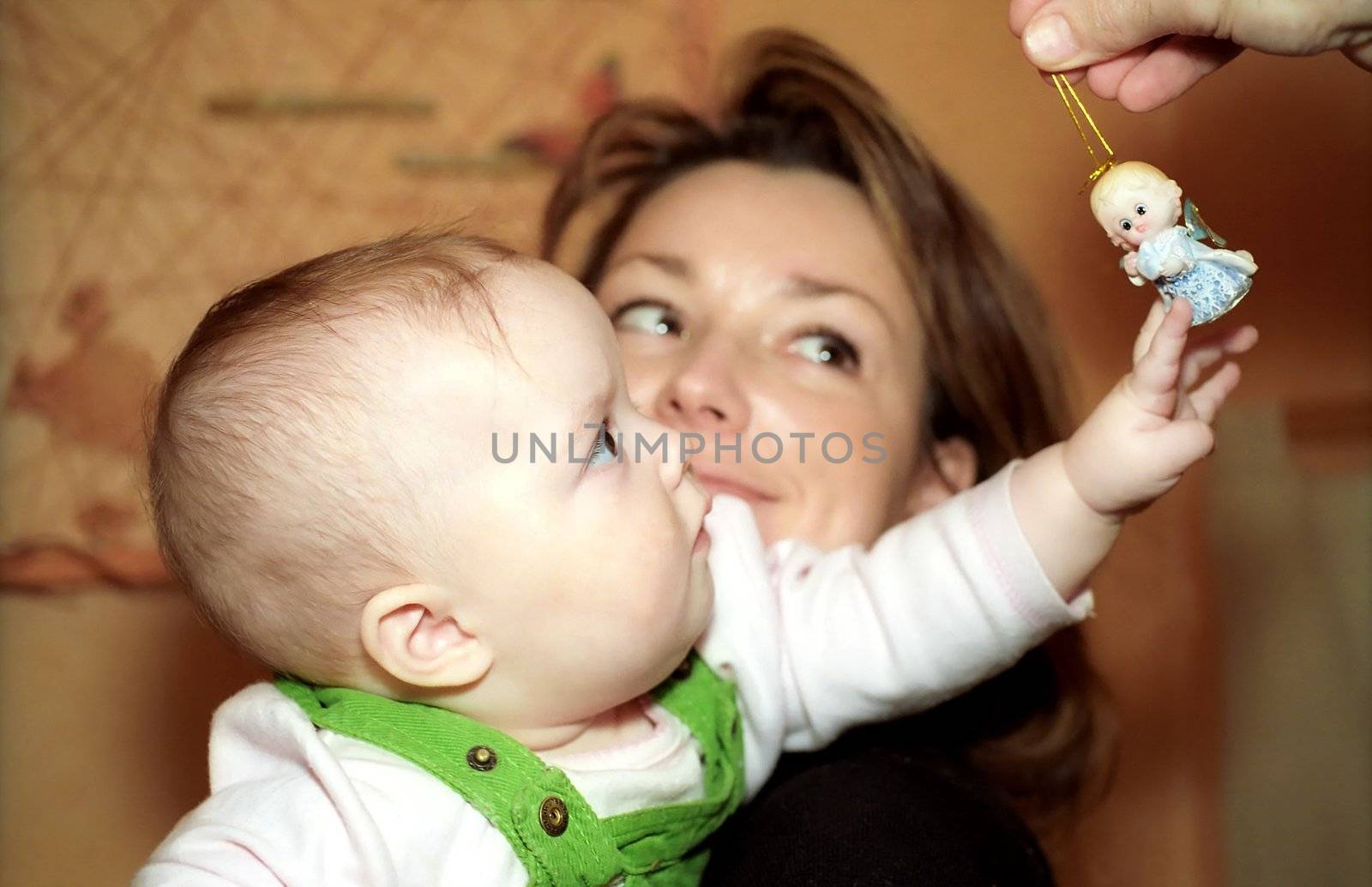 Infant touches an angel figurine 