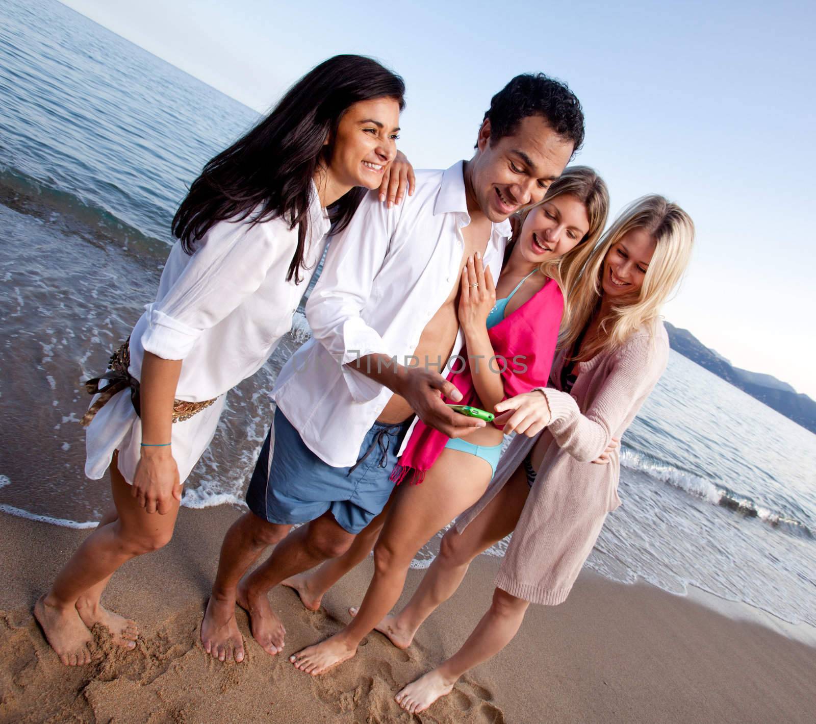 A group of friends laughing at a cellphone, funny text message or picture