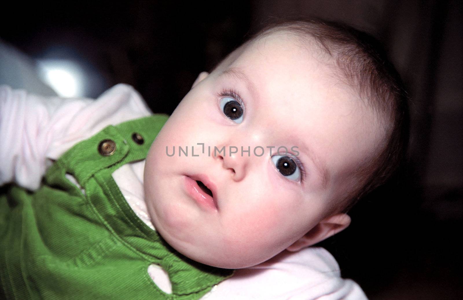 Portrait of infant looking at something with astonishment and circumspection