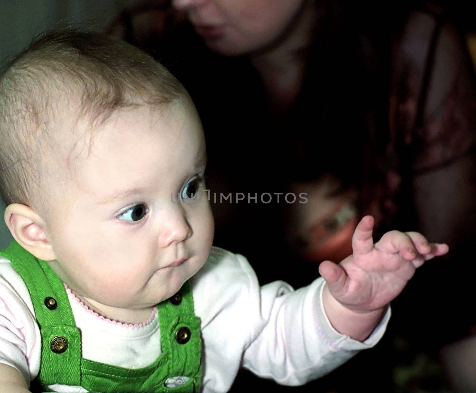 Little baby with forefinger on puting out left hand