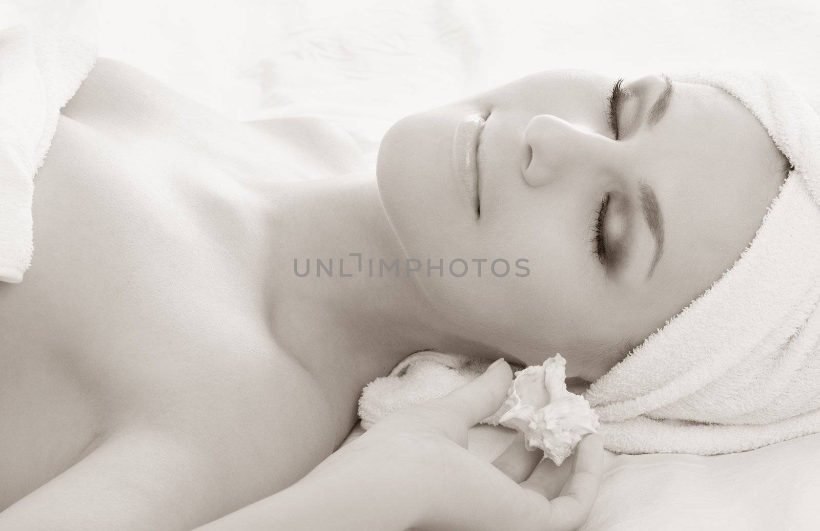 monochrome picture of beautiful lady with sea shell in spa