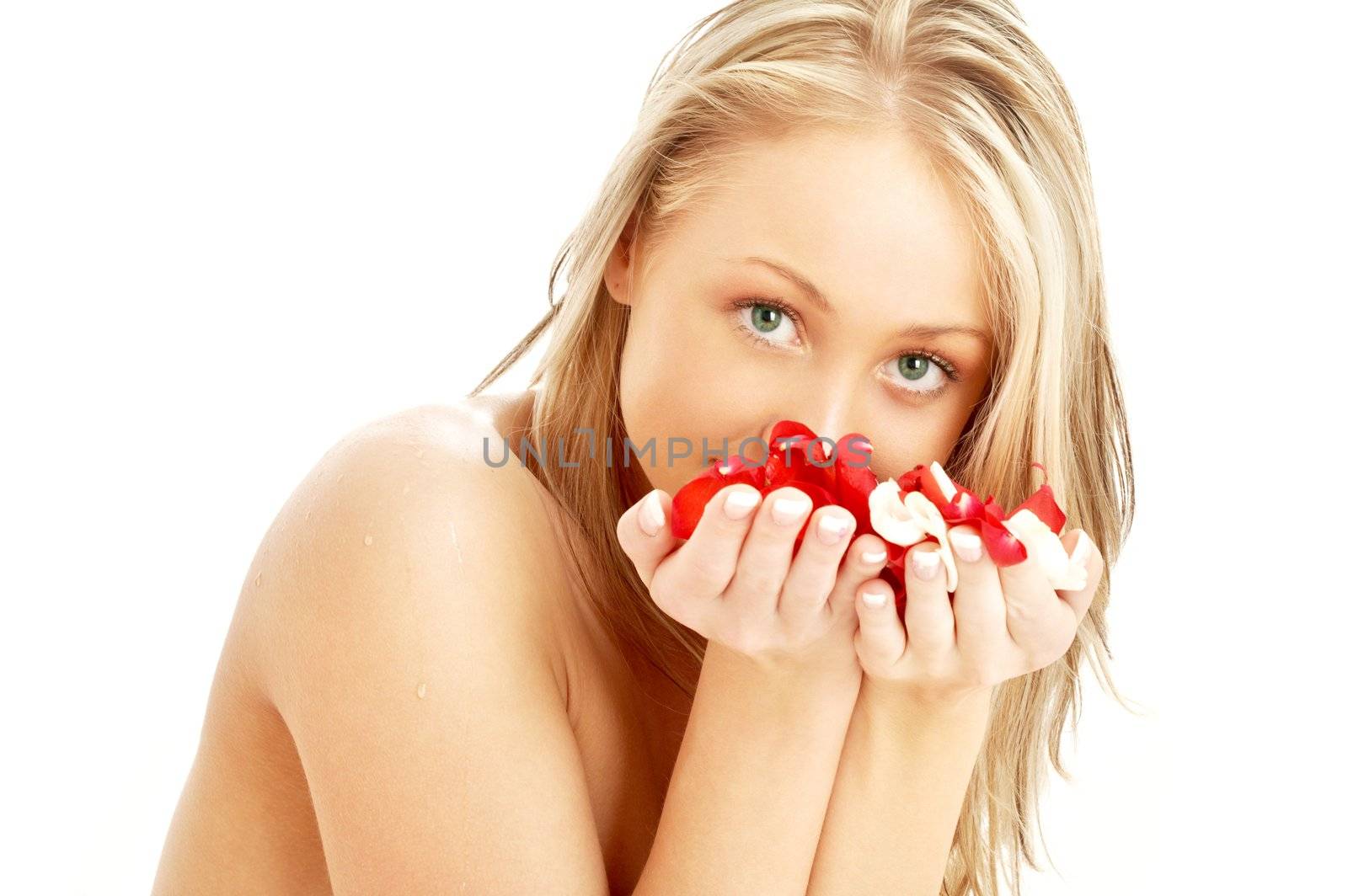 lovely blond in spa with red and white rose petals by dolgachov