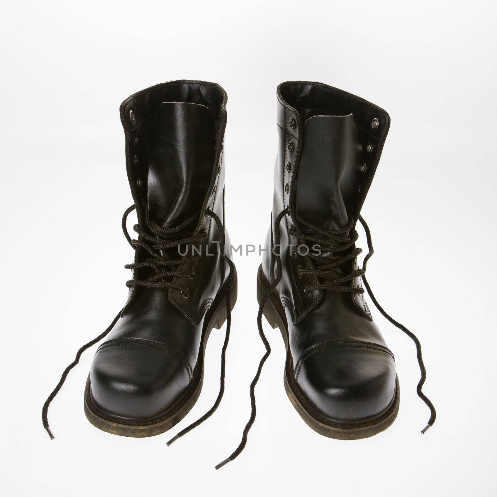 Black leather boots with laces untied.