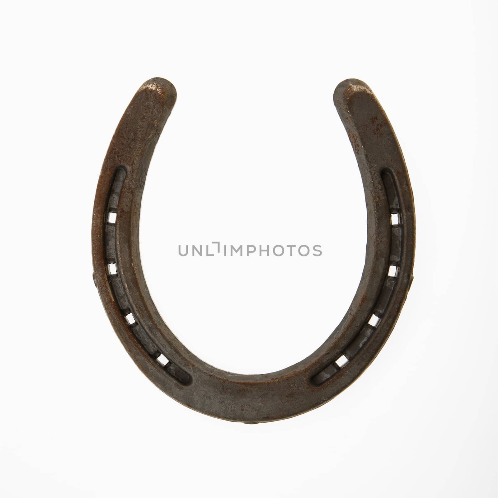 Upside down horseshoe against white background.