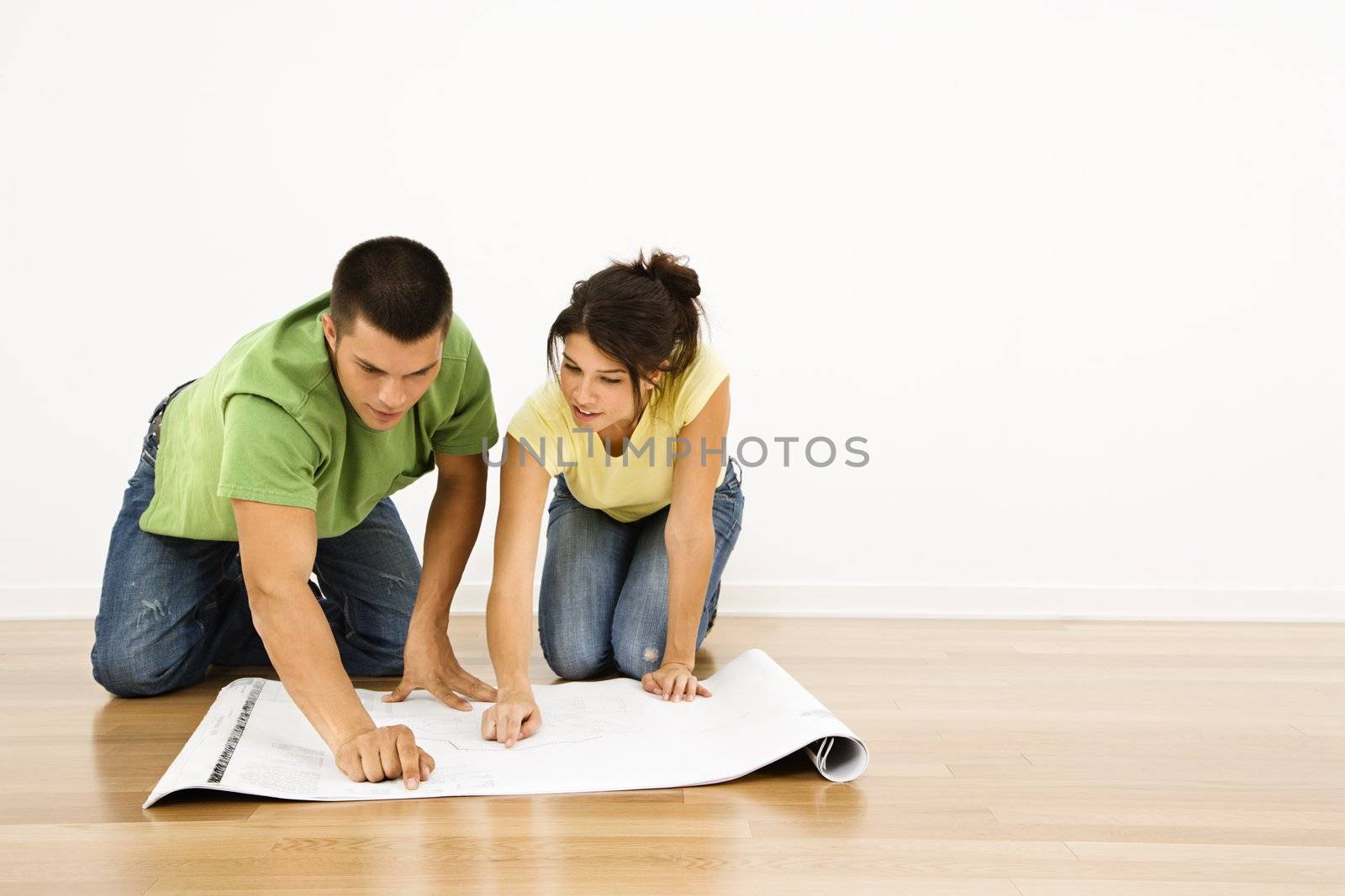 Couple with house plans. by iofoto