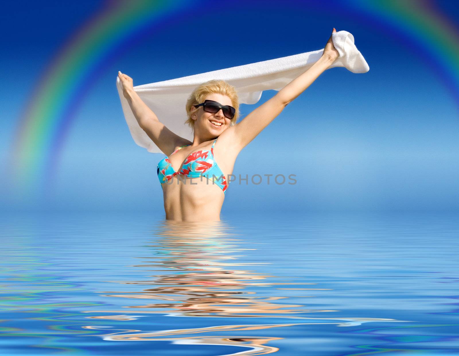 happy girl with towel standing in water by dolgachov