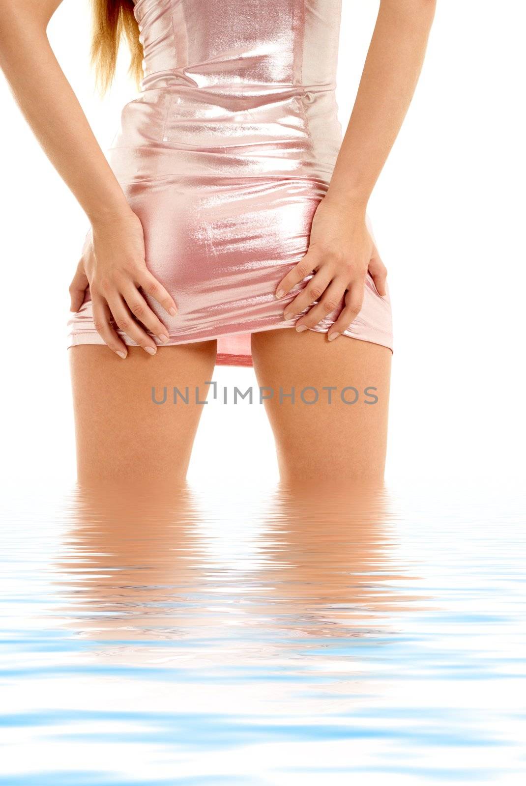 back of lady in pink shiny dress standing in water
