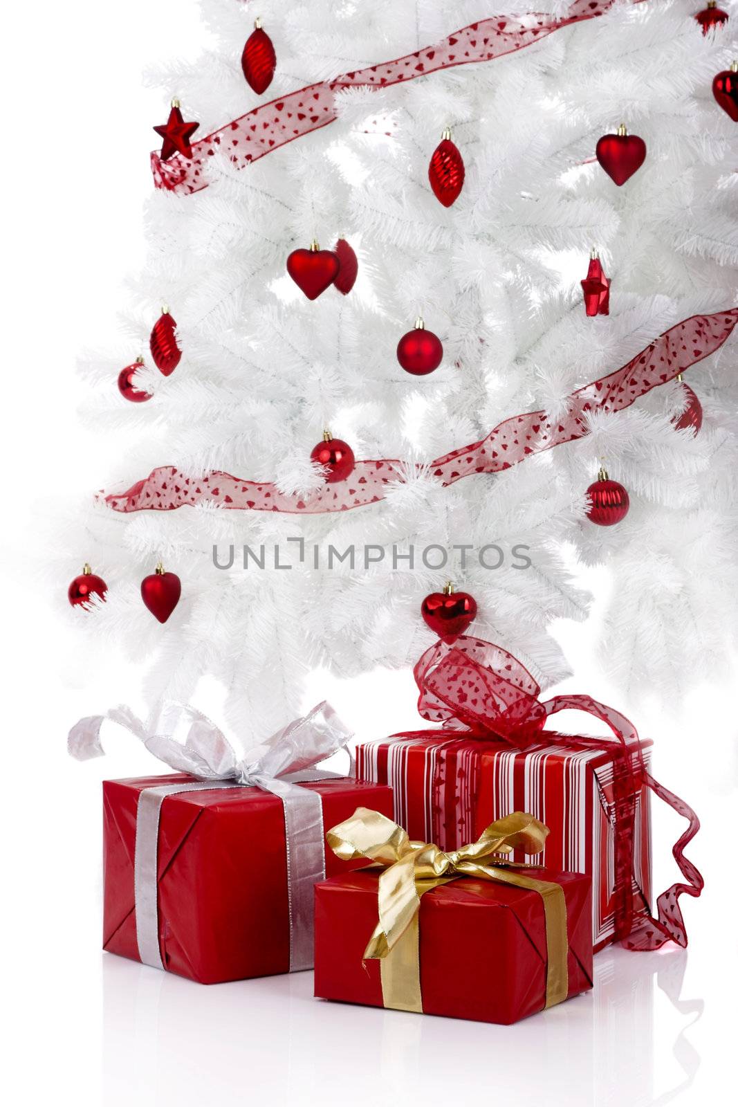 Christmas white tree and gifts over a white background