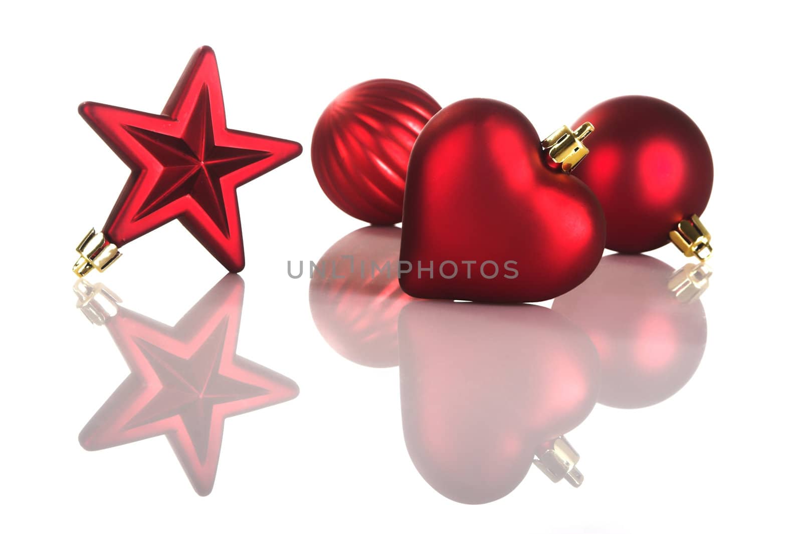 Colored christmas decorations on white with reflection