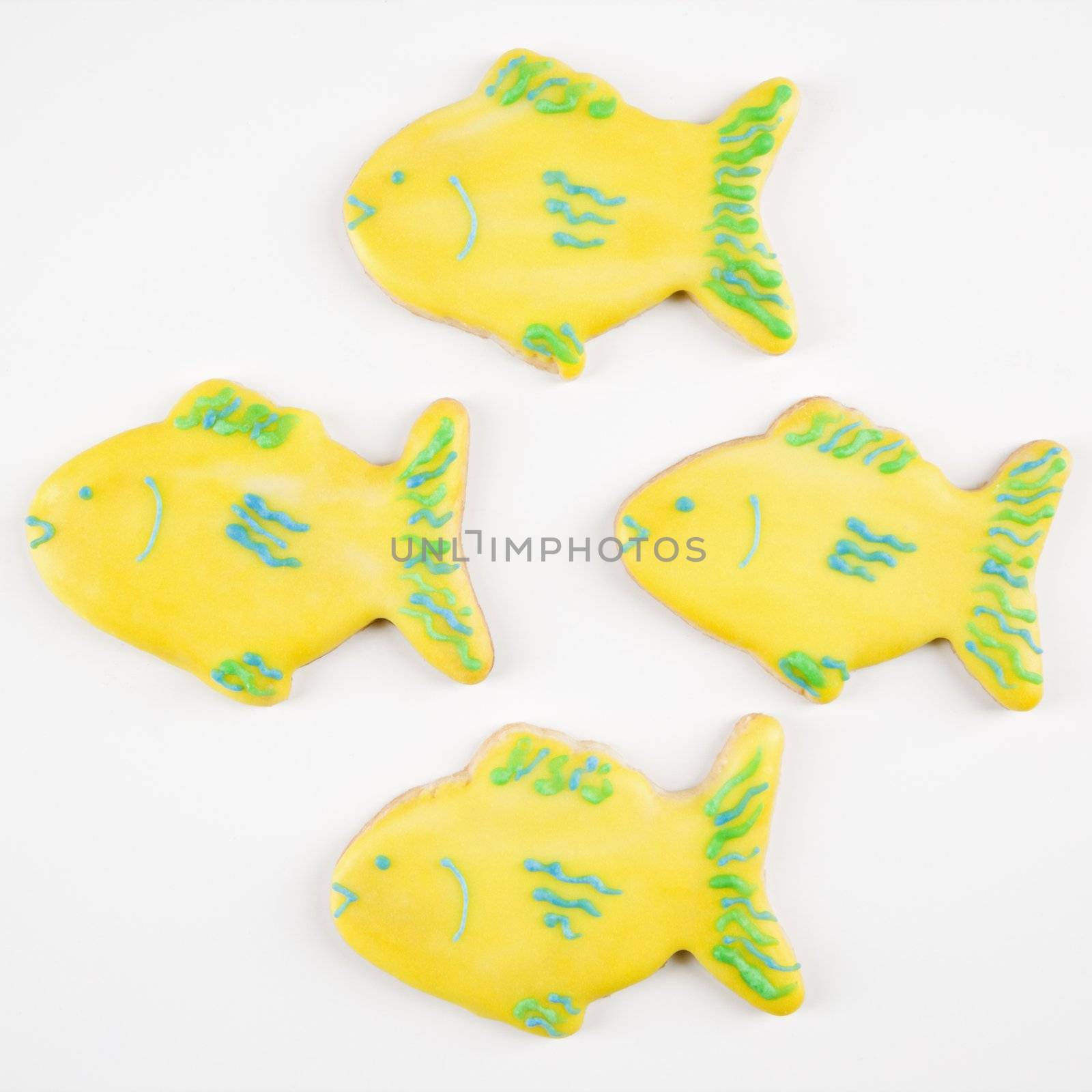 Four fish shaped sugar cookies with decorative icing.