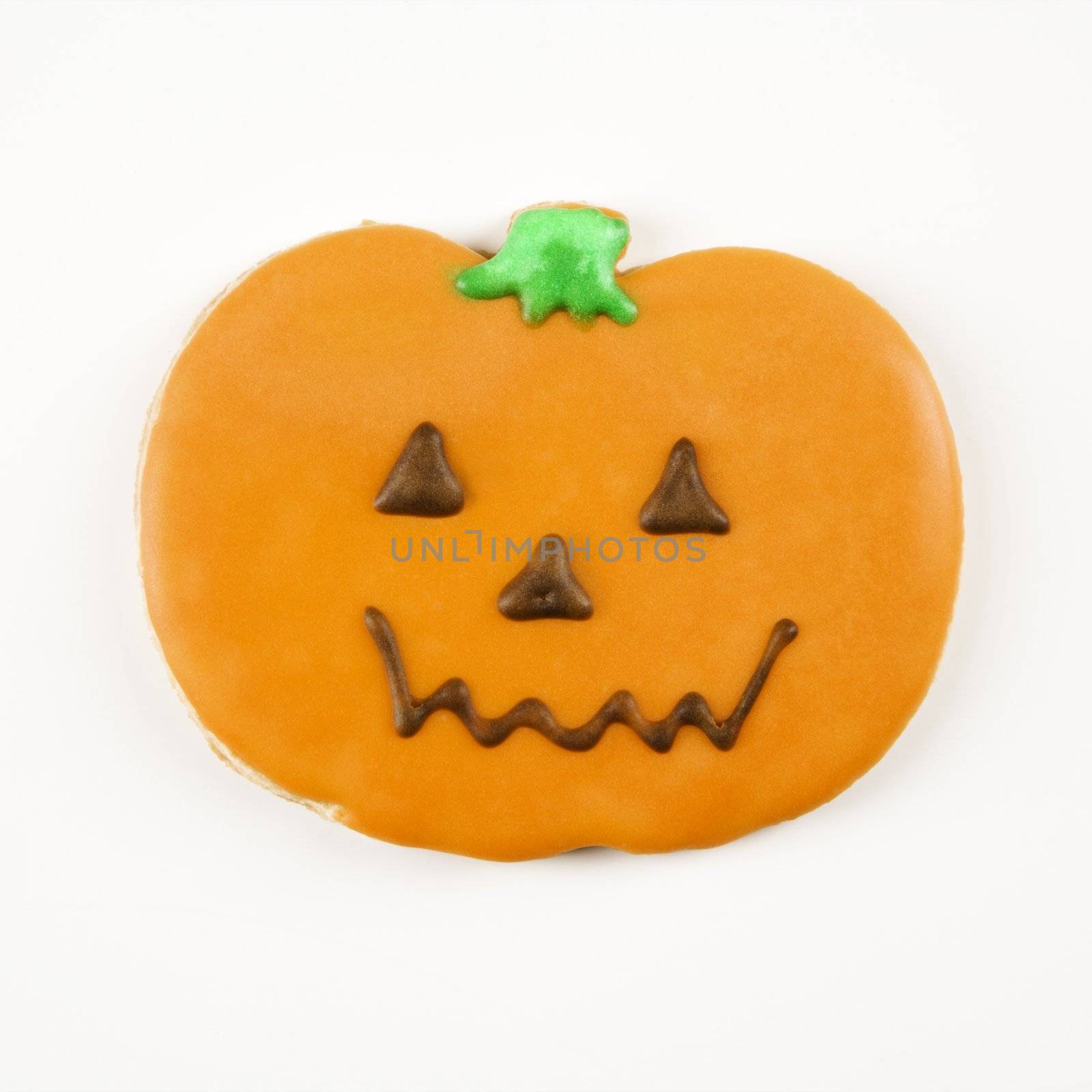 Sugar cookie in shape of jack o lantern with decorative icing.