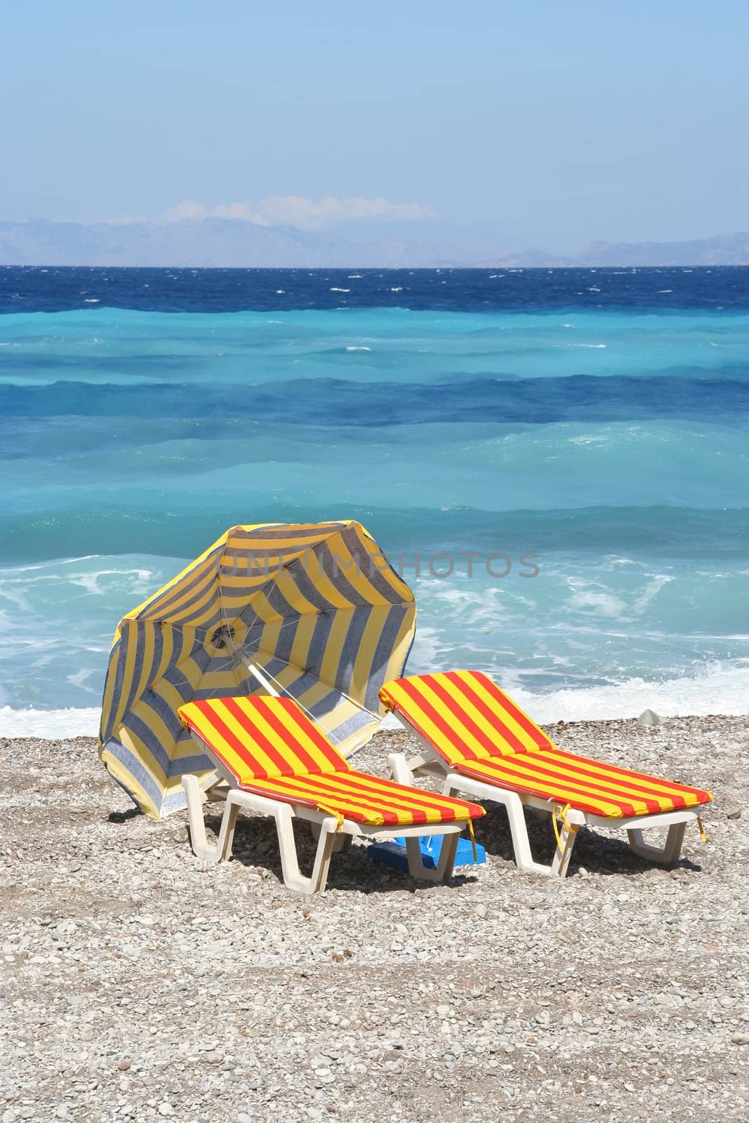 Beach chairs and parasol on a Mediterranean beach