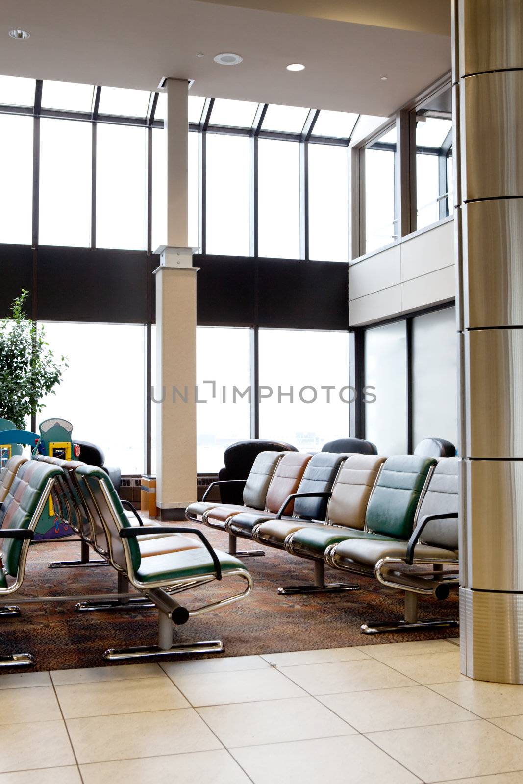 An empty interior of an airport with large windows