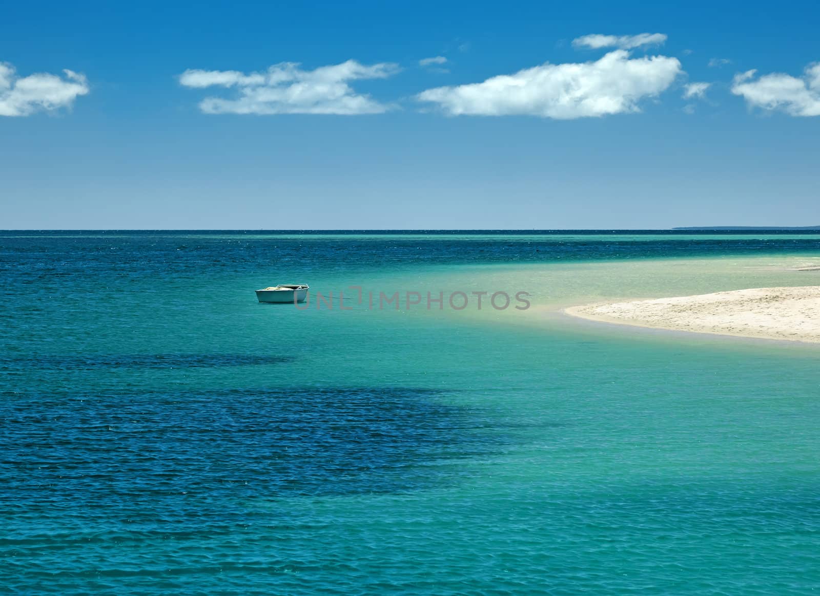 An image of a lonely boat at the beach
