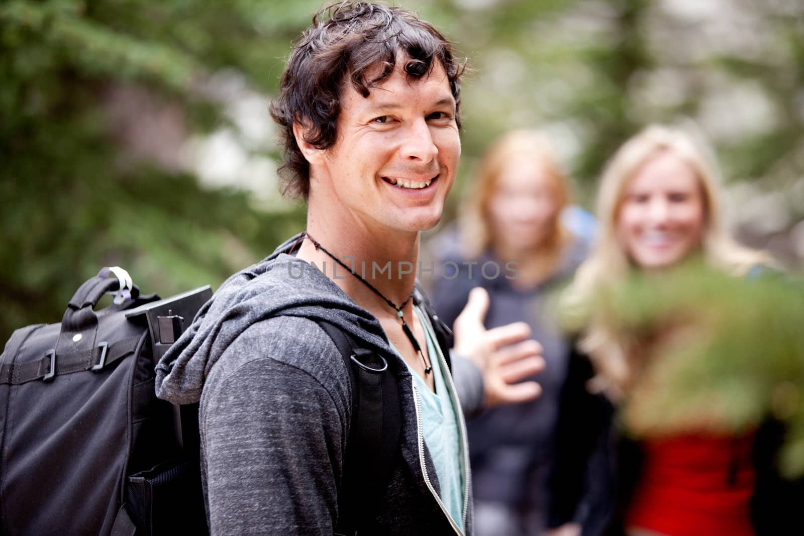 A man is waiting for a girl on an outdoor hike