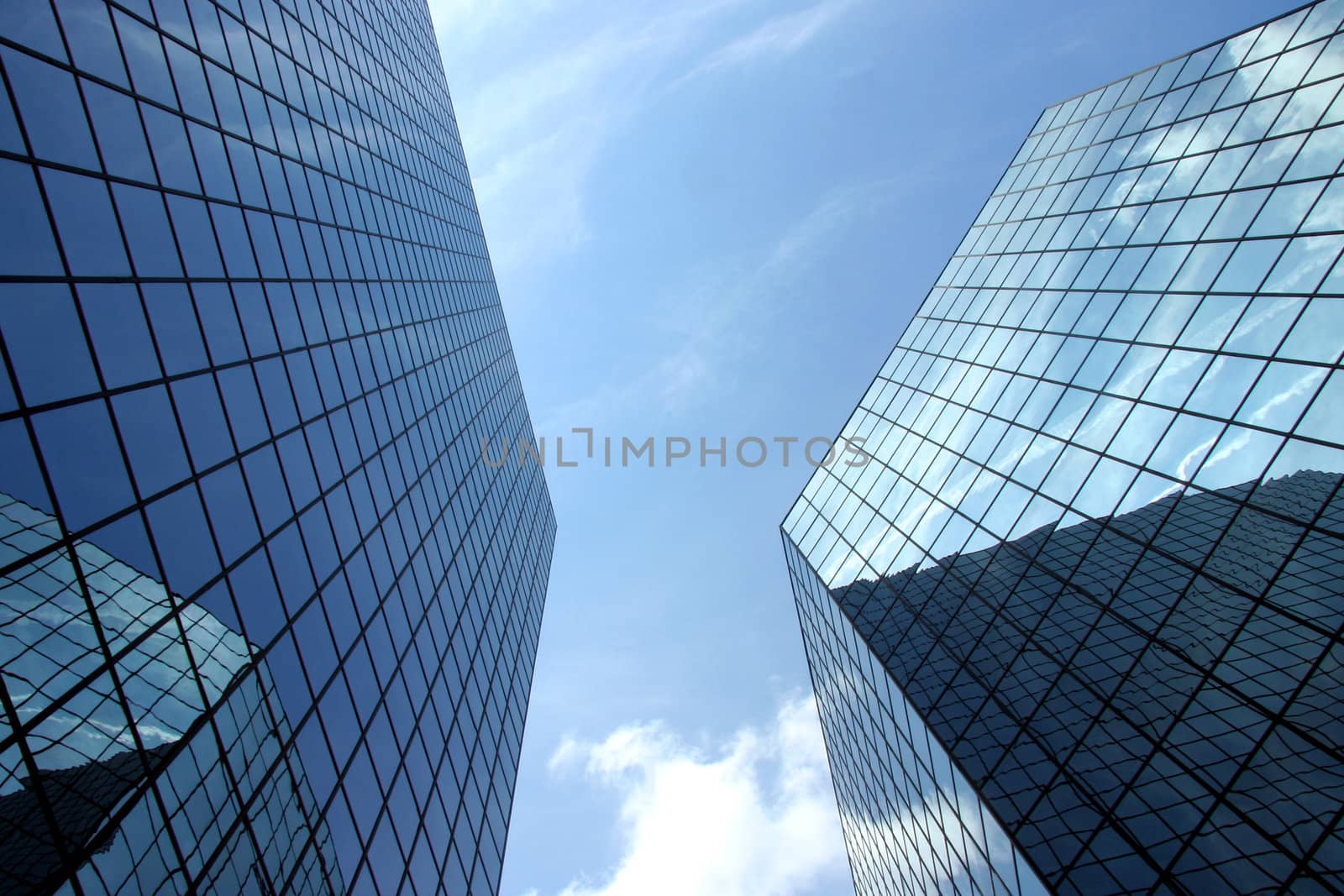 A upward perspective of two very modern skyscrapers