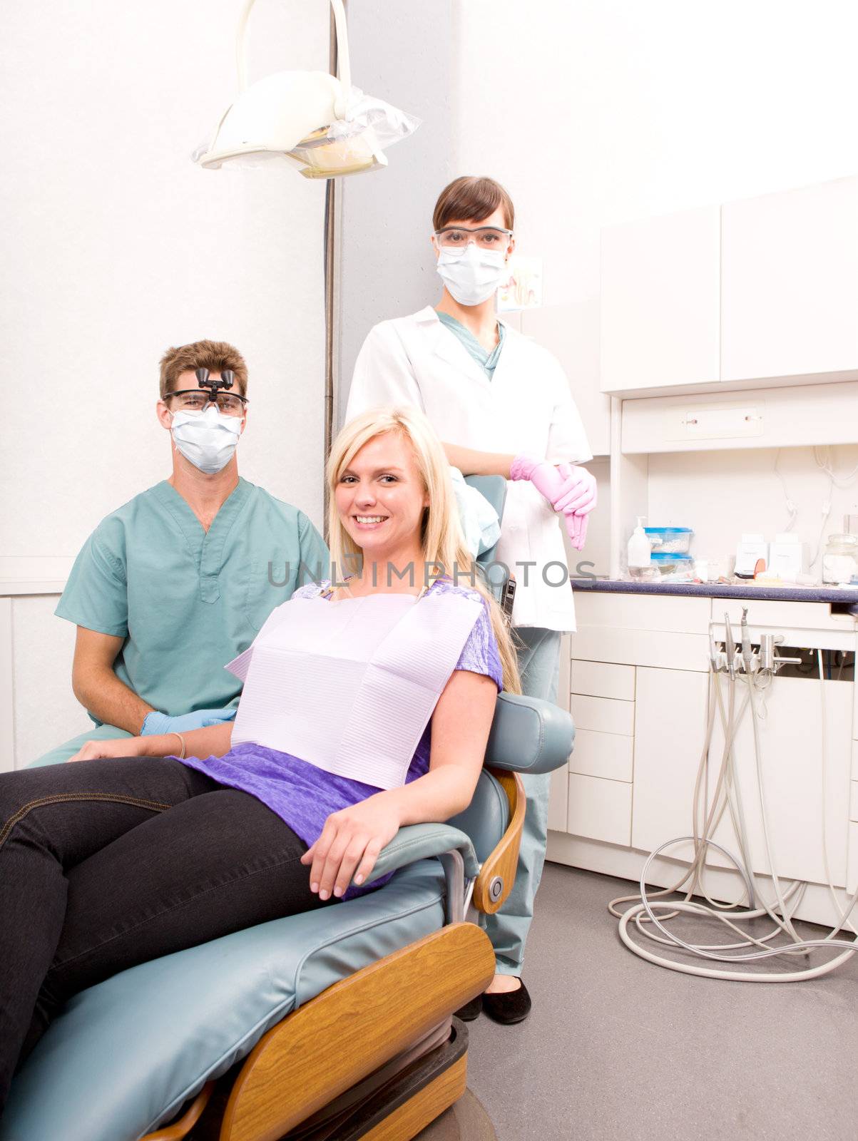 A dentist, assistant and patient in a dental clinic
