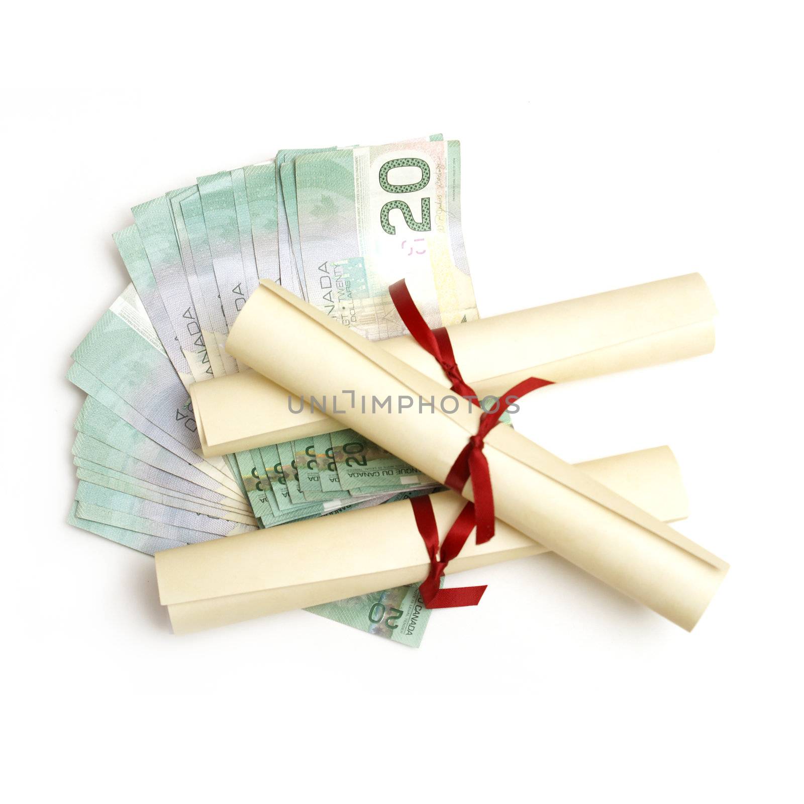 A few diplomas with spread out money for an education or tuition fee concept.