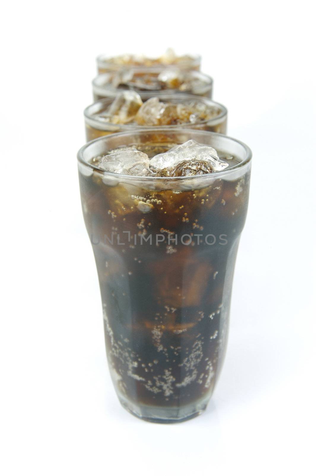 Glasses of cola isolated against a white background