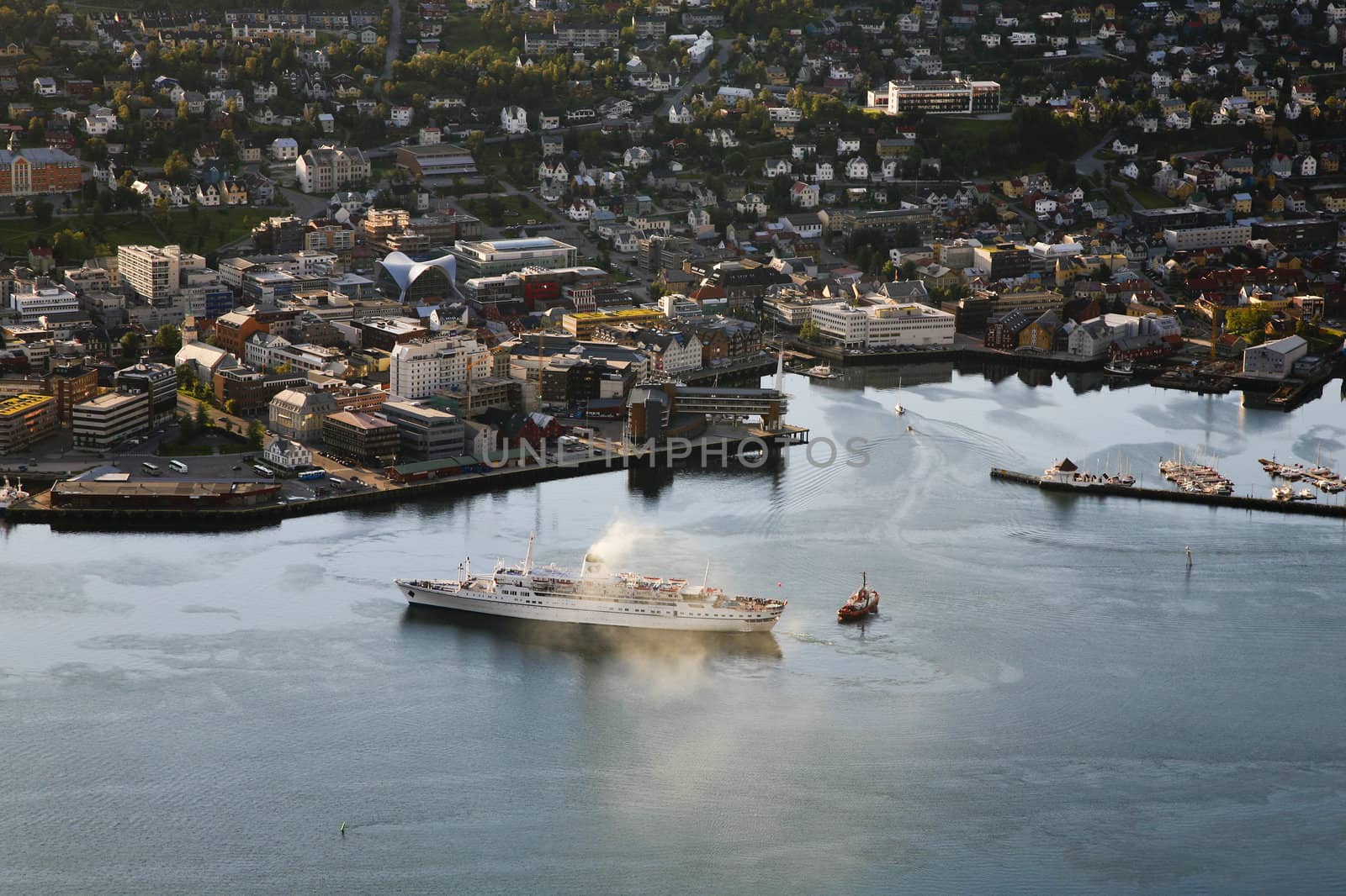 Bird's eye view. of a steam boat leaving city of Tromso, Norway.