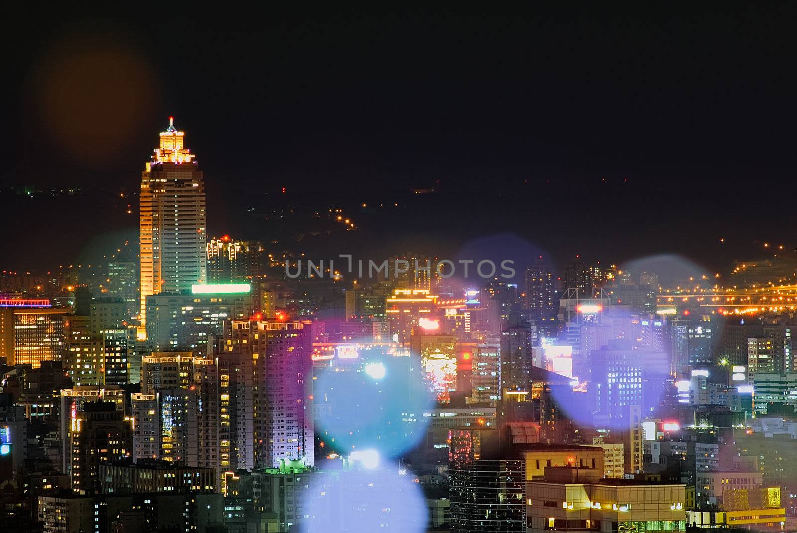 Modern city night with colorful lens blurred in Taipei, Taiwan.