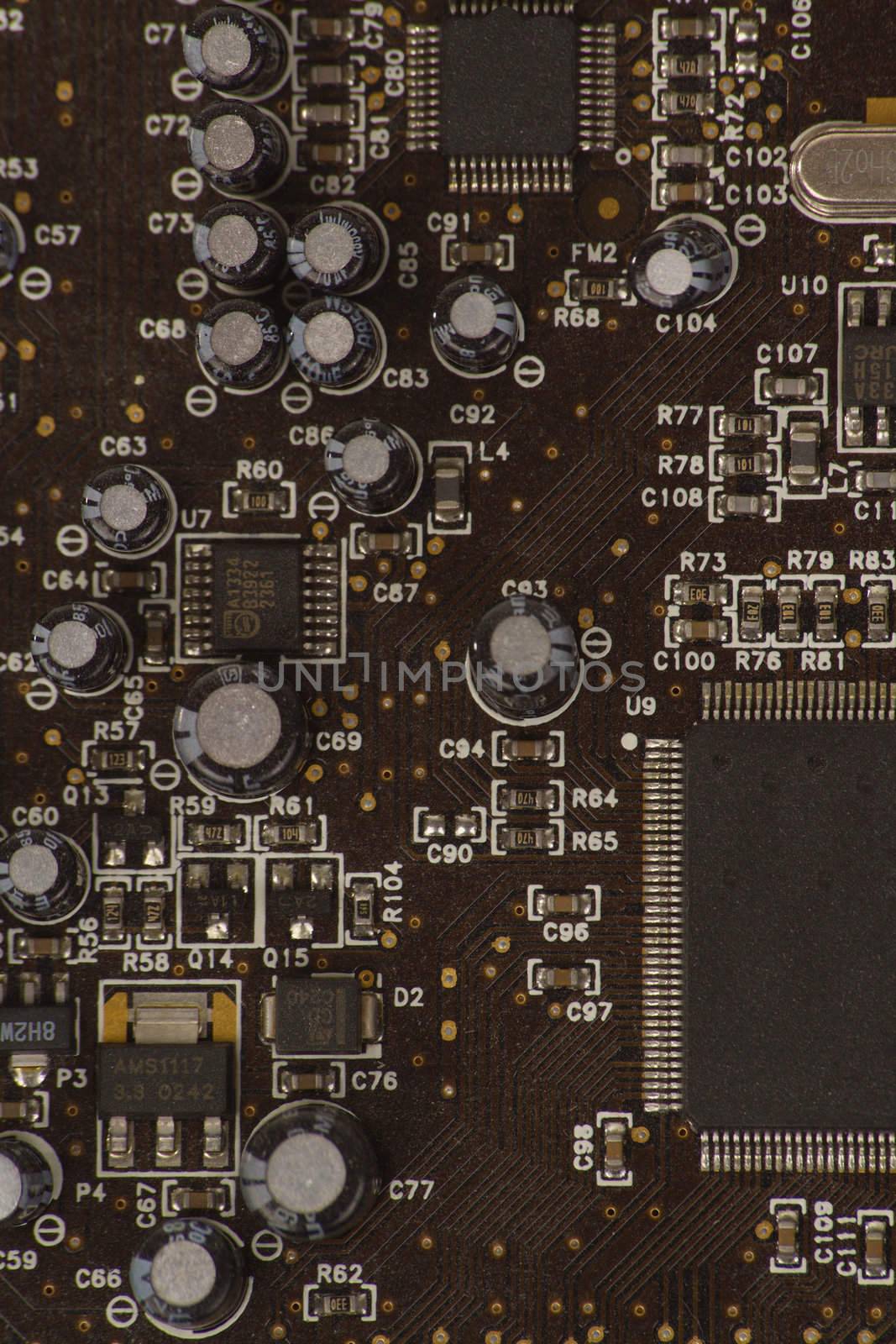 Detail of PC sound card with shallow depth of field to focus on some capacitors