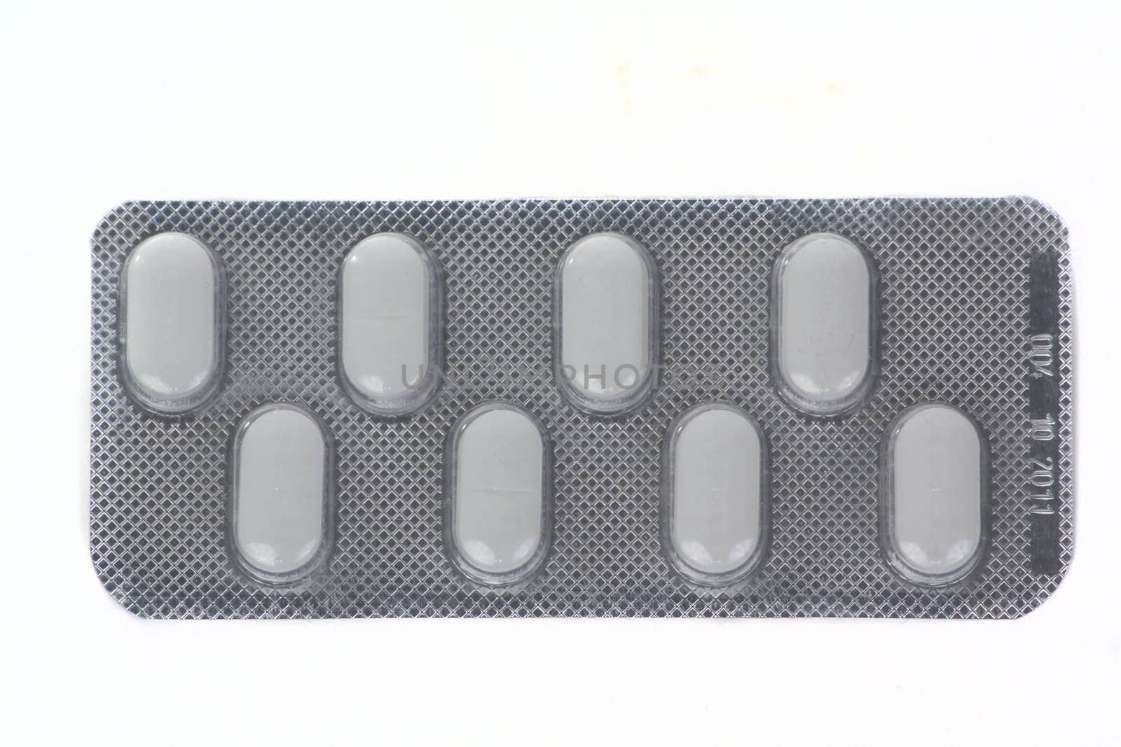 Package of eight pills isolated over white background