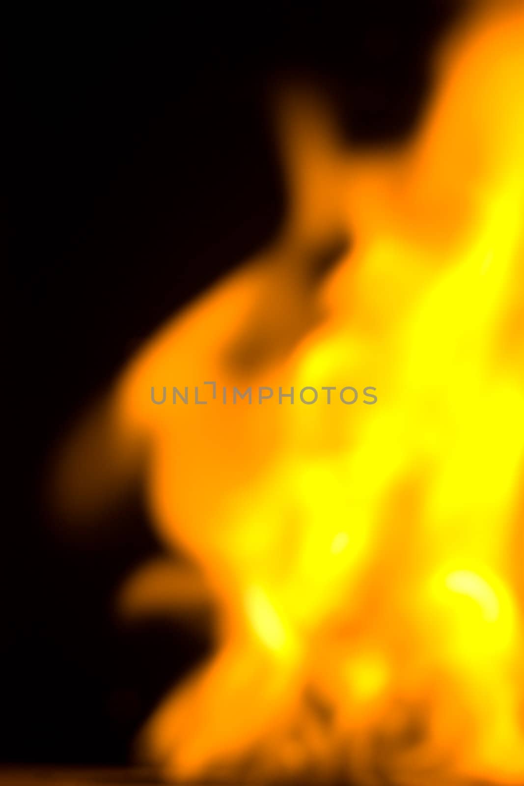 blurry fire flames raising in a dark background