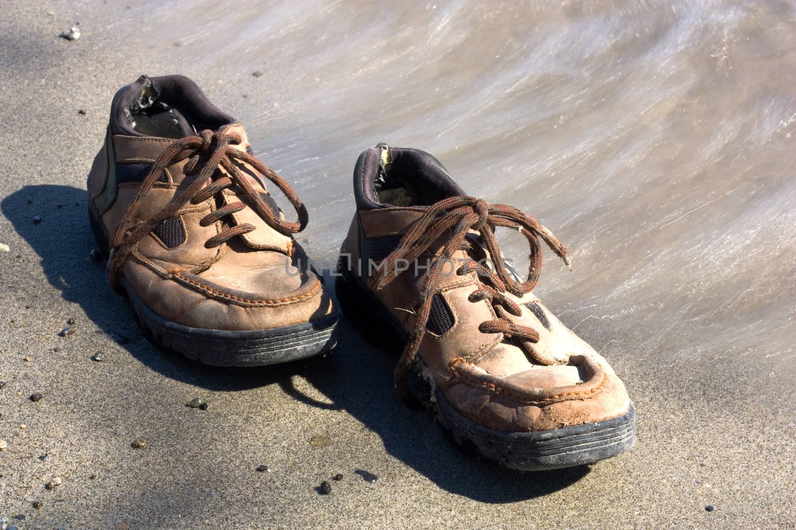 lonely pair of shoes on a lakeshore send