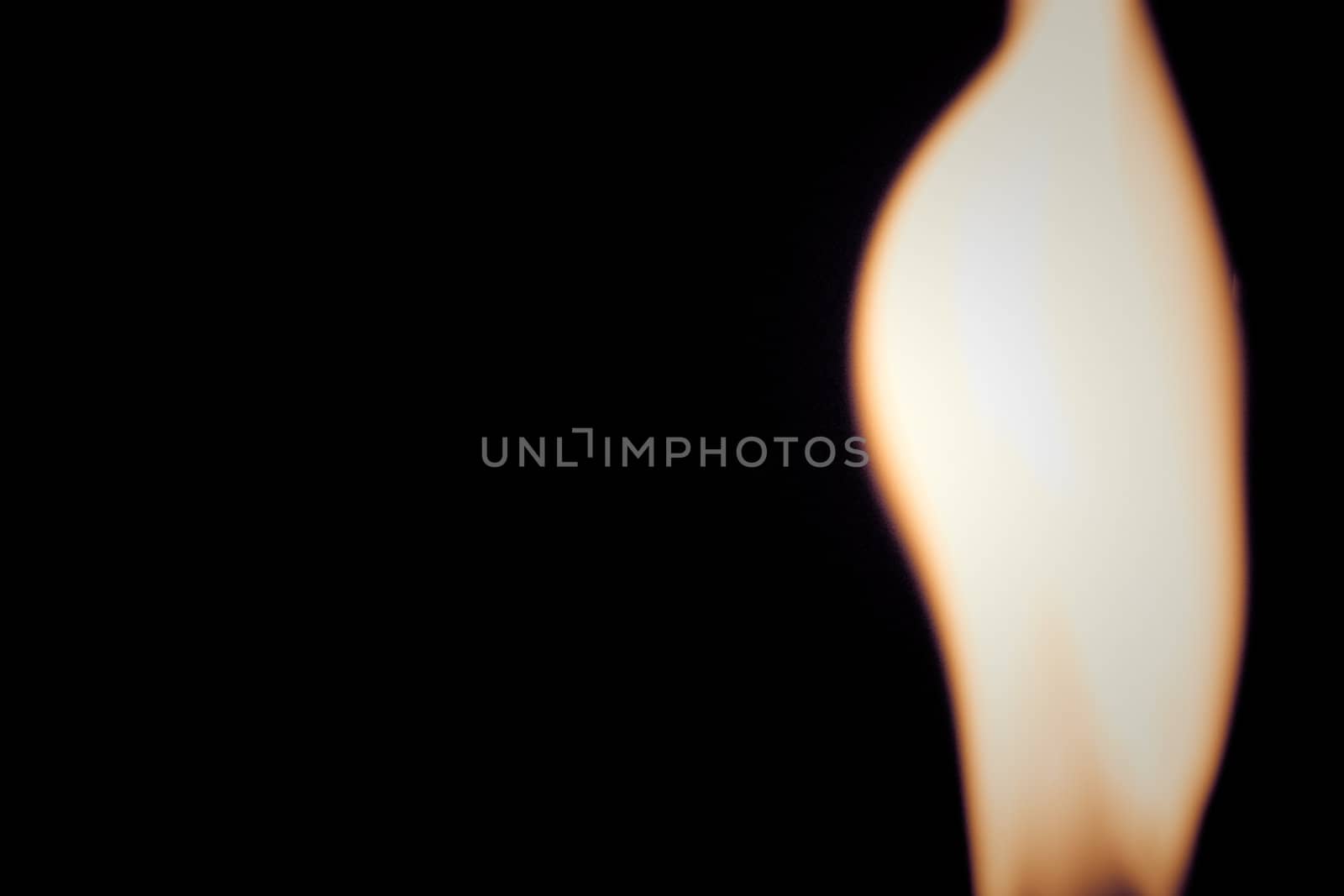 blurry fire flame raising in a dark background