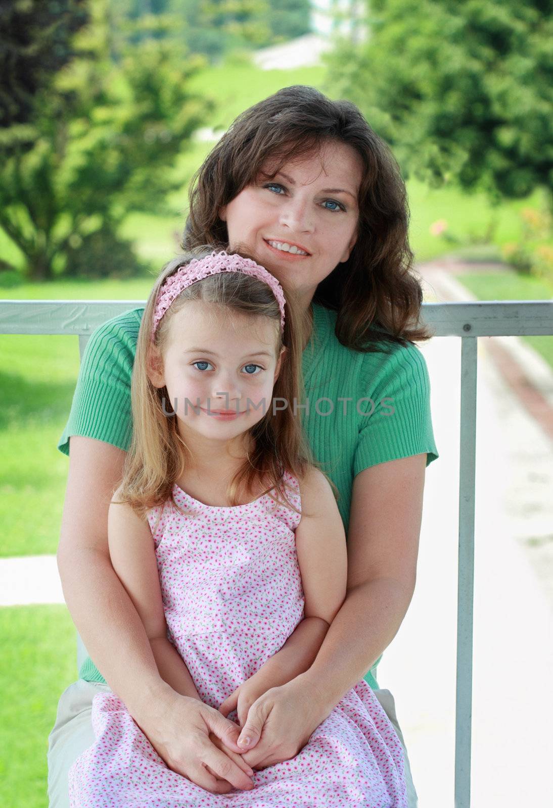 Portrait of a mother in her 40s with her young daughter.