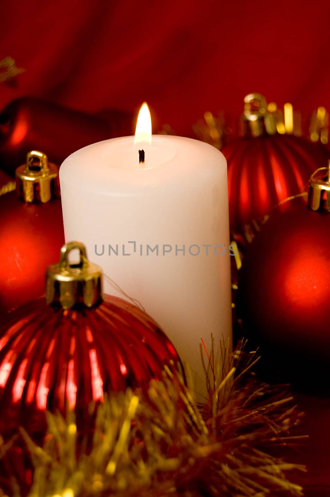 White burning candle over Christmas back
