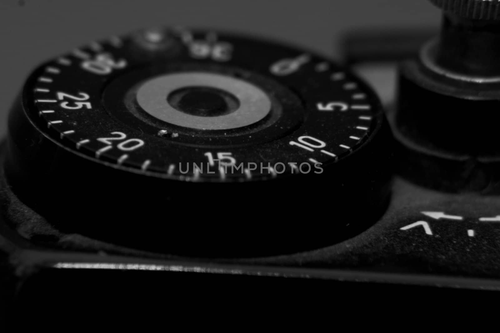 Old analog photo camera in black background