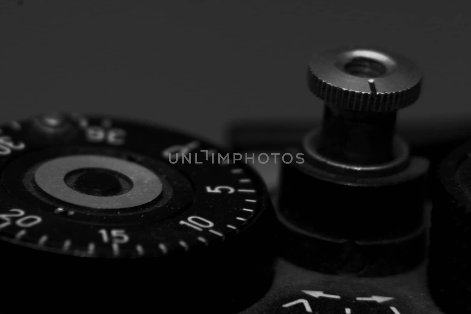 Old analog photo camera in black background