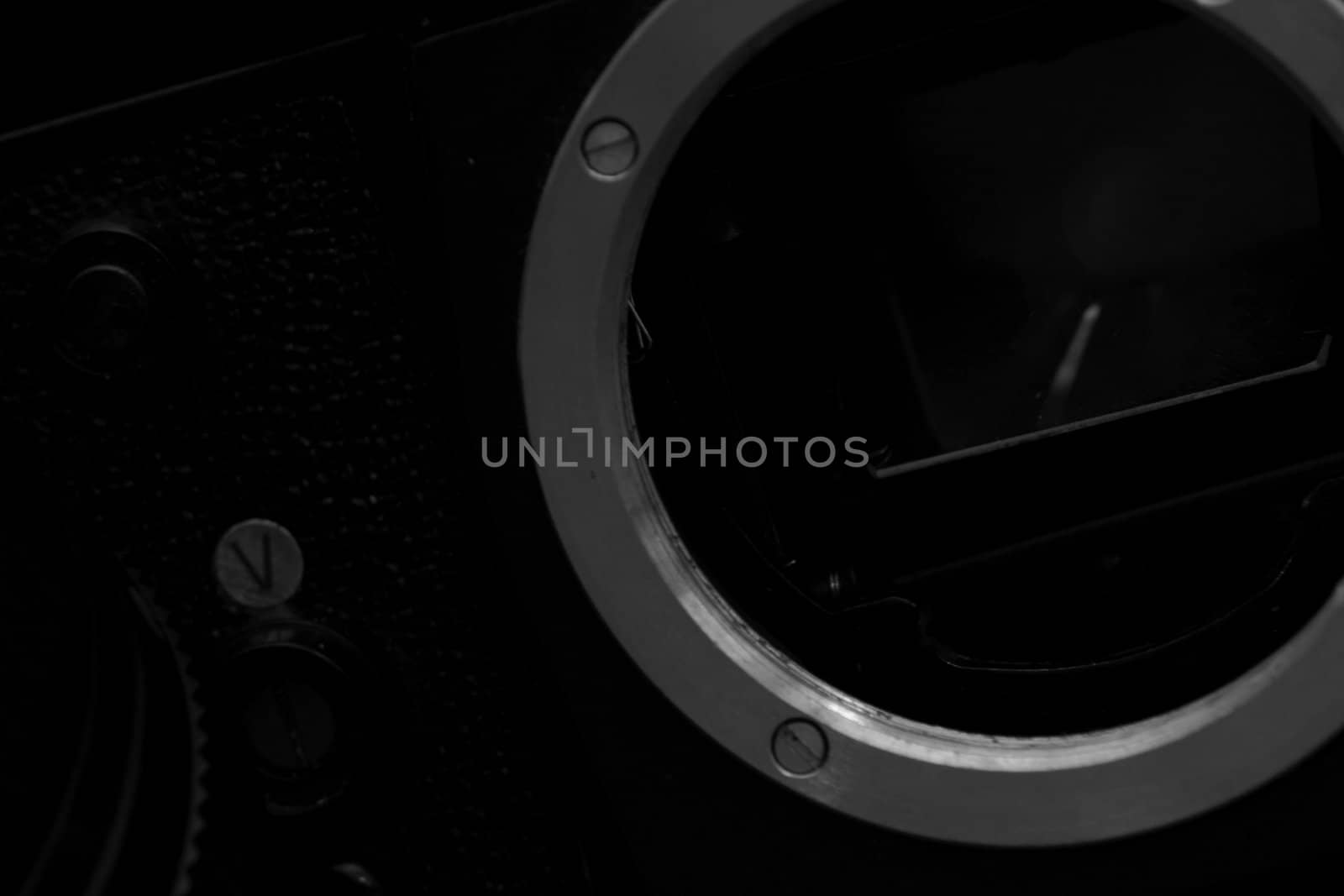 Old analog photo camera in black background