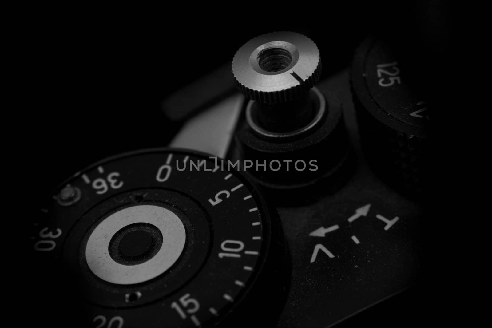 Old analog photo camera in black background