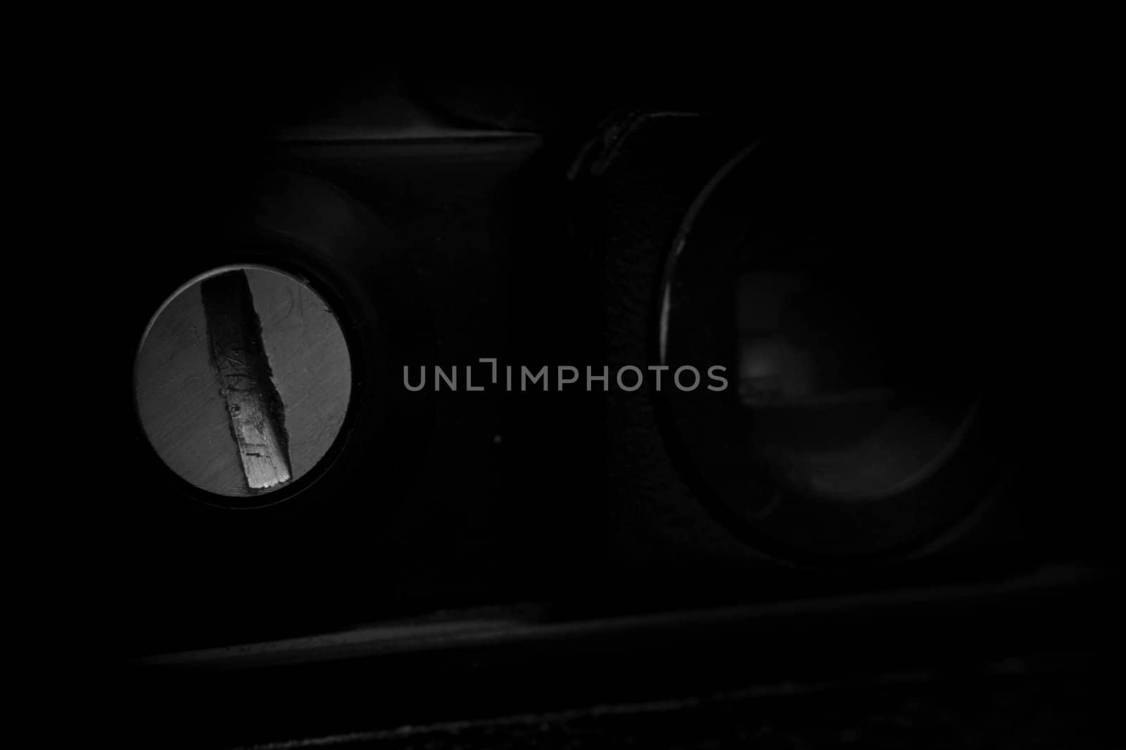 Old analog photo camera in black background