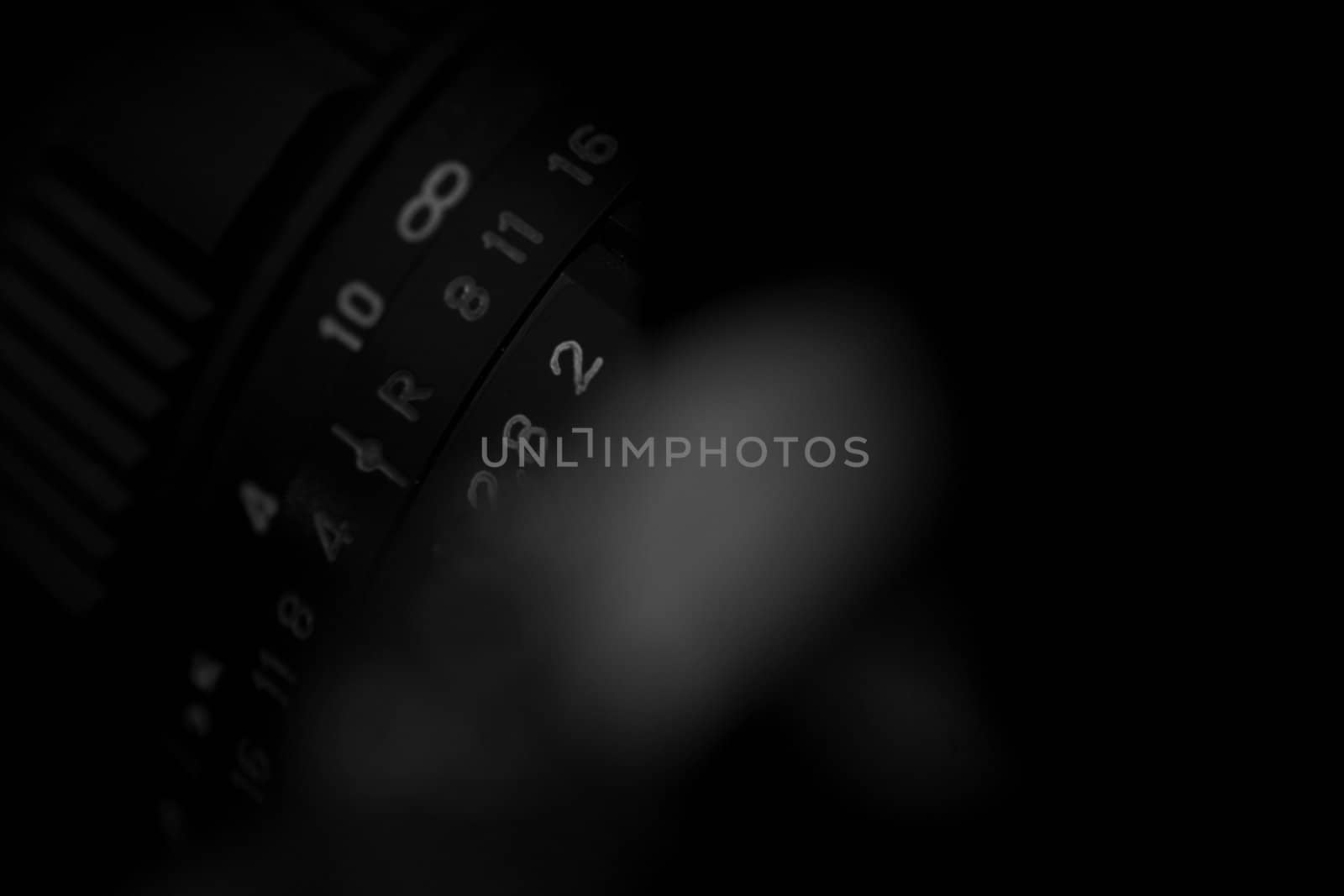 Old analog photo camera in black background