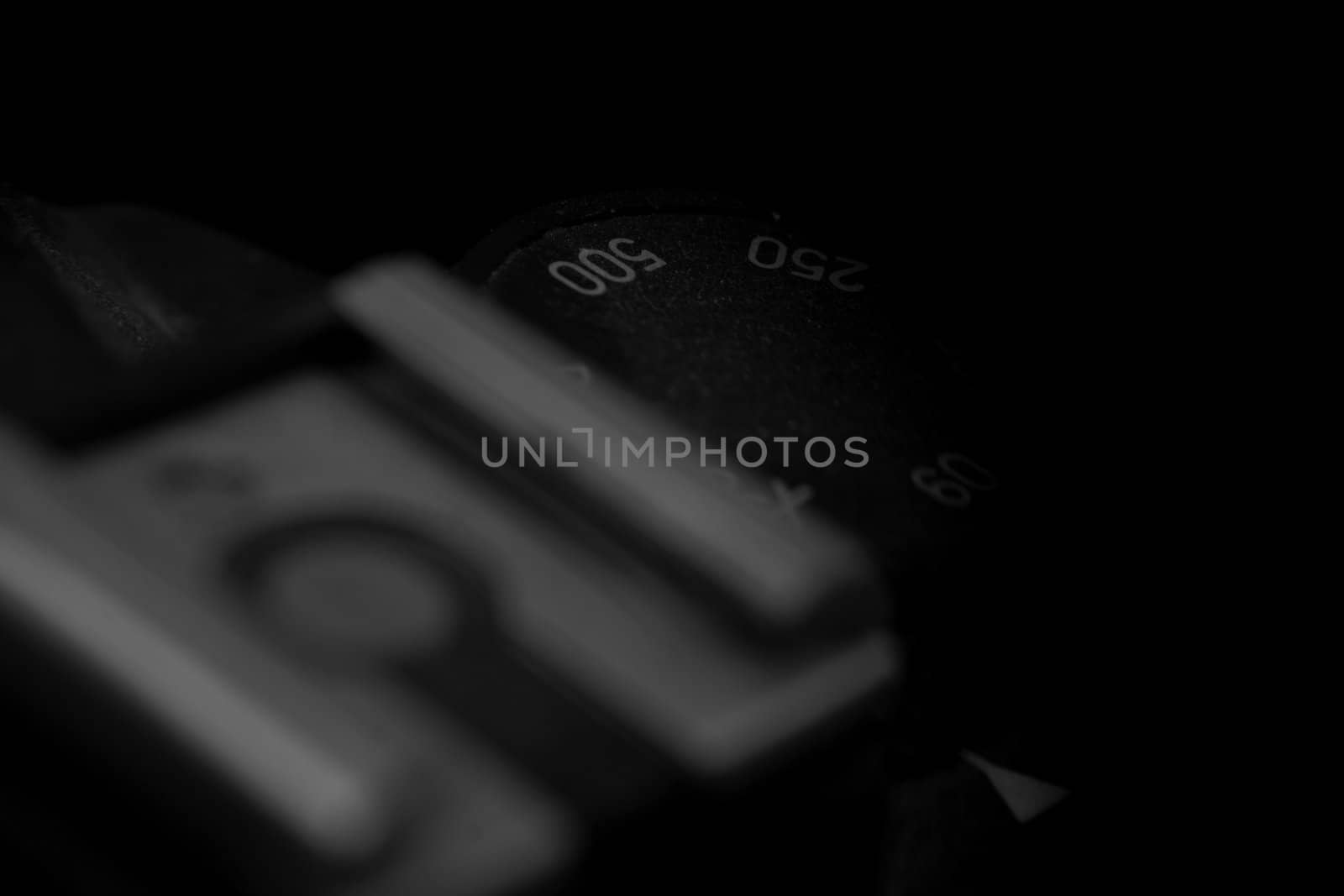 Old analog photo camera in black background