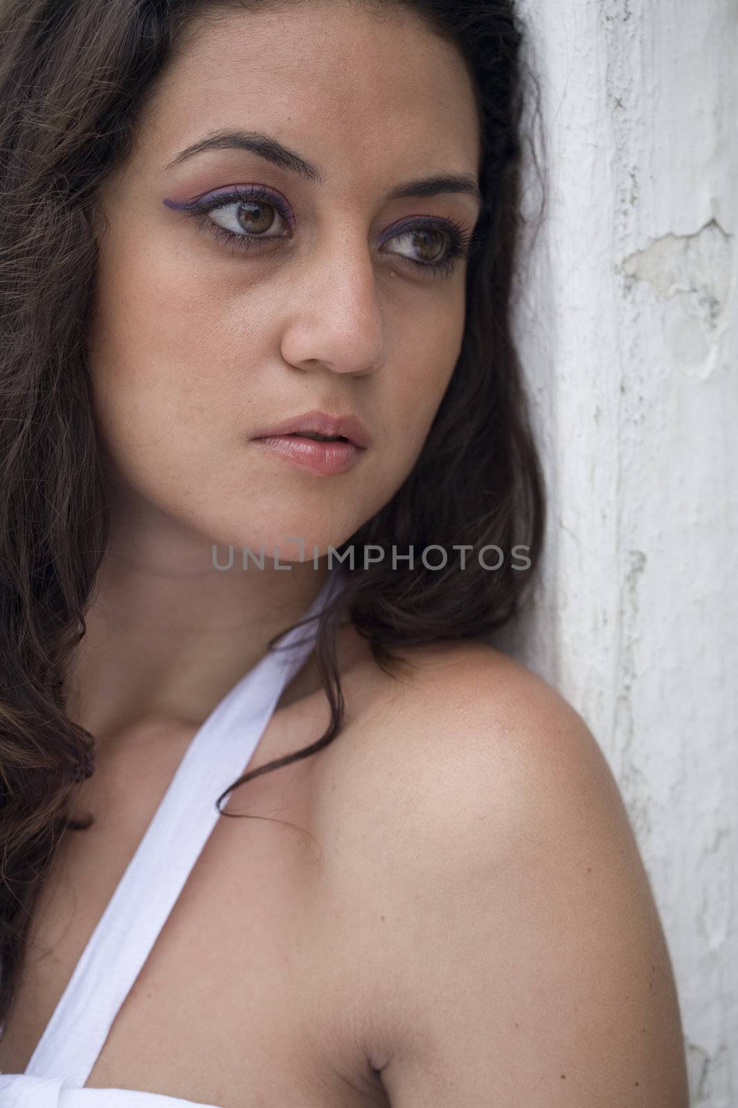 A young brazilian brunette wearing a white dress.