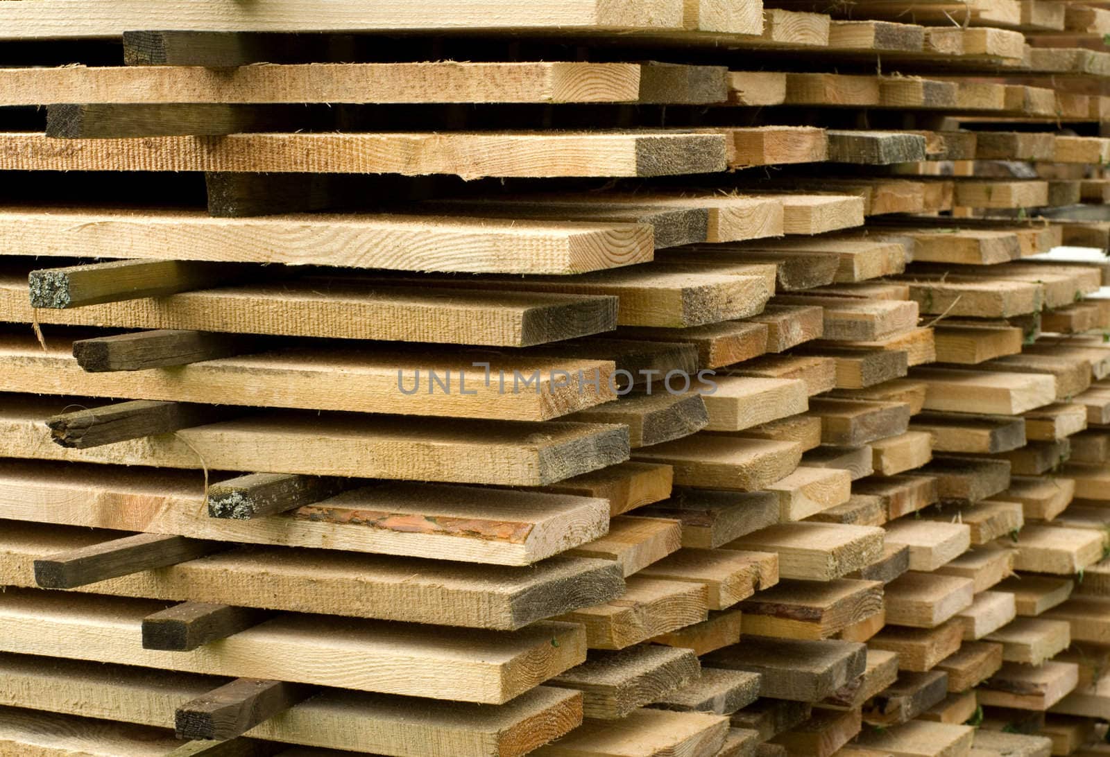 Corner of a stack of wooden boards.