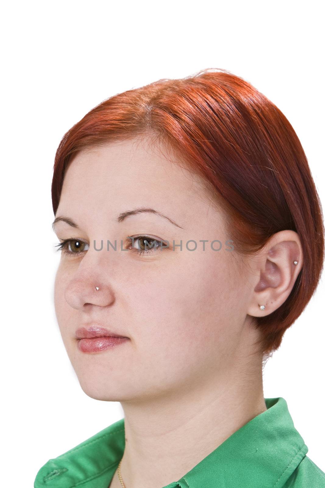 Portrait of a redheaded girl with pierced nose and ear isolated against a white background.