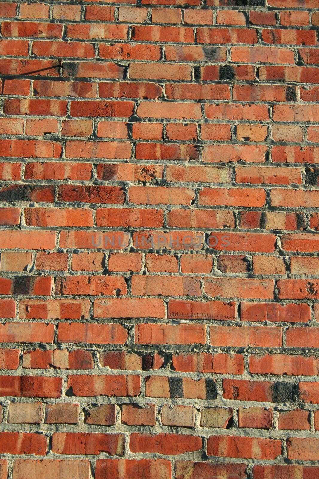 Brickwall over blue sky showing unique pattern.
