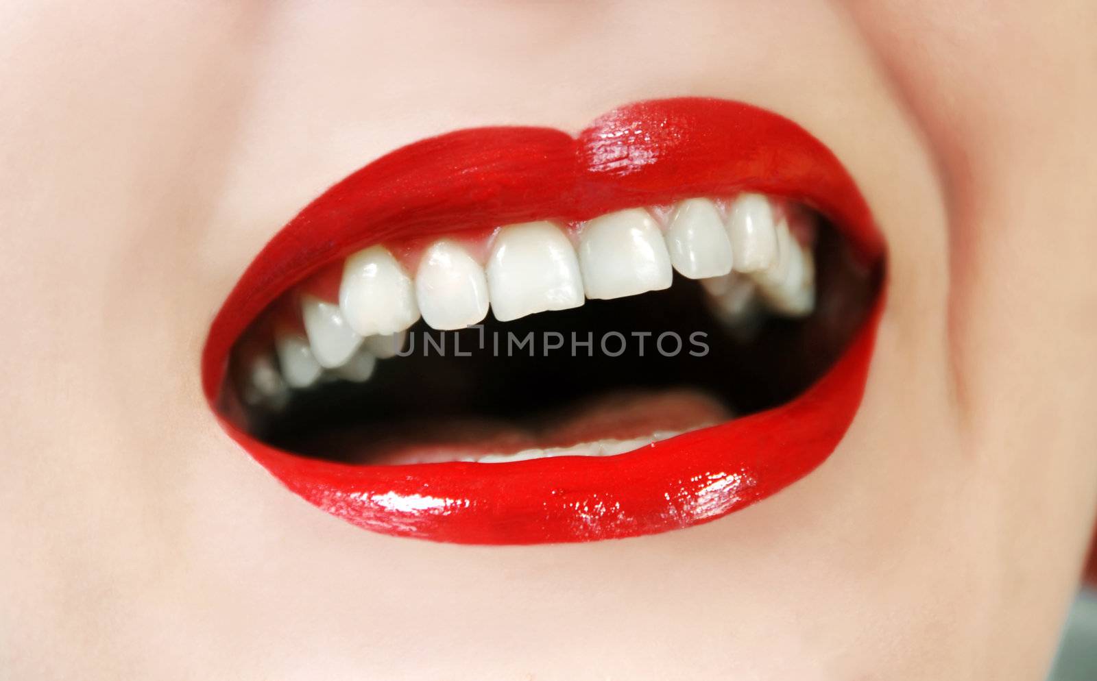 woman opened mouth white teeth and red lipstick laughing
